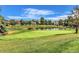 Scenic golf course view with lush green fairways, a serene pond, and blue skies overhead at 13304 E Asbury Dr, Aurora, CO 80014