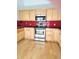 Modern kitchen featuring stainless steel appliances and light hardwood floors at 13304 E Asbury Dr, Aurora, CO 80014
