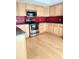 Bright kitchen with light wood cabinets, stainless steel appliances, and eye-catching red backsplash at 13304 E Asbury Dr, Aurora, CO 80014