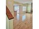 Bright living room features light hardwood floors, an open layout, and views of the kitchen at 13304 E Asbury Dr, Aurora, CO 80014