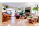 Open-concept living room with stone fireplace and seamless access to the kitchen area at 13304 E Asbury Dr, Aurora, CO 80014
