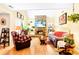 Cozy living room featuring a stone fireplace, vaulted ceilings, and natural light at 13304 E Asbury Dr, Aurora, CO 80014