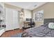 Functional bedroom featuring a cozy bed, a study desk, and a closet for storage at 9023 Apache Plume Dr # C, Parker, CO 80134