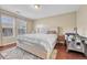 Comfortable bedroom features a large window, modern platform bed, stylish rug, and a baby's changing table at 9023 Apache Plume Dr # C, Parker, CO 80134