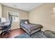 Comfortable bedroom with a modern bed, a desk setup, and a soft rug on the wood floor at 9023 Apache Plume Dr # C, Parker, CO 80134