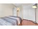 Relaxing bedroom featuring a queen-size bed with a nightstand and closet storage at 9023 Apache Plume Dr # C, Parker, CO 80134