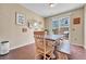 Bright dining room with a rustic wooden table and bench, decorated with modern wall art at 9023 Apache Plume Dr # C, Parker, CO 80134