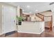 Inviting entryway offering a glimpse into the kitchen, granite countertop, and the staircase at 9023 Apache Plume Dr # C, Parker, CO 80134