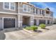 The exterior showcases a well-kept townhome complex with driveways, garages, and manicured shrubs at 9023 Apache Plume Dr # C, Parker, CO 80134
