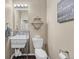 Stylish half bathroom featuring a unique sink with metal frame and modern decor at 9023 Apache Plume Dr # C, Parker, CO 80134