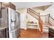Bright kitchen adjacent to a staircase featuring stainless steel refrigerator and granite countertop at 9023 Apache Plume Dr # C, Parker, CO 80134