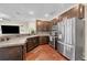Modern kitchen featuring stainless steel appliances, dark cabinets, and a granite countertop at 9023 Apache Plume Dr # C, Parker, CO 80134