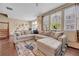 Cozy living room showcasing a spacious sectional sofa, wood floors, and natural light at 9023 Apache Plume Dr # C, Parker, CO 80134