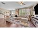 Spacious living room featuring a large sofa, wood floors, and ample natural light at 9023 Apache Plume Dr # C, Parker, CO 80134
