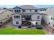Back exterior of a two-story home featuring a backyard deck, patio, hot tub and a large backyard at 18541 W 93Rd Pl, Arvada, CO 80007