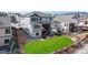 Aerial view of the back exterior featuring a spacious backyard, a patio, a deck, a hot tub and wood fencing at 18541 W 93Rd Pl, Arvada, CO 80007