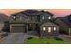 Beautiful two-story home featuring a well-maintained yard, a two-car garage, and a charming stone facade at 18541 W 93Rd Pl, Arvada, CO 80007