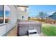 Side view of a portable hot tub in a partially fenced backyard with grass and decorative rock at 18541 W 93Rd Pl, Arvada, CO 80007