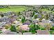 Aerial view of a neighborhood showcasing well-maintained homes, green lawns, and mature trees at 76 Buckthorn Dr, Littleton, CO 80127