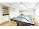 Finished basement area with a wet bar, pool table, and laminate floors at 76 Buckthorn Dr, Littleton, CO 80127