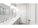 Bright bathroom with double sinks, marble countertops, updated fixtures, and a stylish mirror at 76 Buckthorn Dr, Littleton, CO 80127