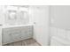Bathroom with a double sink vanity, framed mirrors, and tiled floors for a clean look at 76 Buckthorn Dr, Littleton, CO 80127
