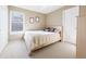Bright bedroom with neutral walls, a large window, and carpeted floors at 76 Buckthorn Dr, Littleton, CO 80127