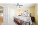 Light filled bedroom featuring floral bedding, a ceiling fan, and soft neutral paint for a relaxing ambiance at 76 Buckthorn Dr, Littleton, CO 80127