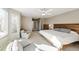 Bright bedroom with neutral tones, large windows, ceiling fan, and a comfortable seating area at 76 Buckthorn Dr, Littleton, CO 80127