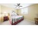 Comfortable bedroom with a floral comforter, a ceiling fan, and a bright window at 76 Buckthorn Dr, Littleton, CO 80127