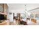 Open dining room with hardwood floors and large windows offering scenic outdoor views at 76 Buckthorn Dr, Littleton, CO 80127