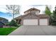 Charming two-story home featuring a three-car garage and a well-manicured front lawn at 76 Buckthorn Dr, Littleton, CO 80127