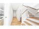 Clean hallway with a white finish, hardwood floors, and access to many rooms at 76 Buckthorn Dr, Littleton, CO 80127
