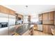 A traditional kitchen with wood cabinets, stainless steel appliances and granite countertops on the island at 76 Buckthorn Dr, Littleton, CO 80127