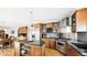Modern kitchen with granite countertops, stainless steel appliances, and wooden cabinetry at 76 Buckthorn Dr, Littleton, CO 80127