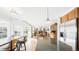 Bright, open kitchen with granite island, stainless appliances, and hardwood floors at 76 Buckthorn Dr, Littleton, CO 80127