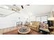 Light-filled living room featuring wood floors, vaulted ceiling, staircase, and comfortable seating at 76 Buckthorn Dr, Littleton, CO 80127