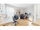 Home office featuring hardwood floors, two workstations with black chairs, and natural light at 76 Buckthorn Dr, Littleton, CO 80127