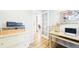 Cozy home office with light wood desk, white trim, and hardwood floors at 76 Buckthorn Dr, Littleton, CO 80127