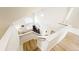 Open view of the home's staircase, highlighting the pristine white walls and hardwood floors at 76 Buckthorn Dr, Littleton, CO 80127