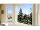 Inviting window view of snowy rooftops and beautiful trees in a well-maintained neighborhood at 76 Buckthorn Dr, Littleton, CO 80127