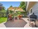 Relaxing back deck featuring stylish outdoor furniture and a convenient grill at 5 Cliffrose, Littleton, CO 80127