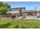 Exterior of the house highlighting a spacious back deck and landscaped yard at 5 Cliffrose, Littleton, CO 80127