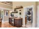 Inviting bar area with a beverage fridge, floating shelves, and adjacent laundry room at 5 Cliffrose, Littleton, CO 80127