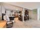 Finished basement featuring wood-look shelving, an air hockey table and carpeted floors at 5 Cliffrose, Littleton, CO 80127