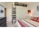 Bedroom with a ladder to an upper level bookshelf and a closet with folding doors at 5 Cliffrose, Littleton, CO 80127