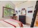 Bright bedroom featuring large arched window and a ladder to an upper level at 5 Cliffrose, Littleton, CO 80127