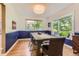 Elegant dining room with large window, hardwood floors, and a stylish light fixture above the dining table at 5 Cliffrose, Littleton, CO 80127