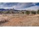 Beautiful equestrian grounds featuring scenic mountain views and white fencing at 5 Cliffrose, Littleton, CO 80127