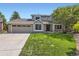 Charming two-story home featuring a well-manicured lawn, a two-car garage, and inviting curb appeal at 5 Cliffrose, Littleton, CO 80127